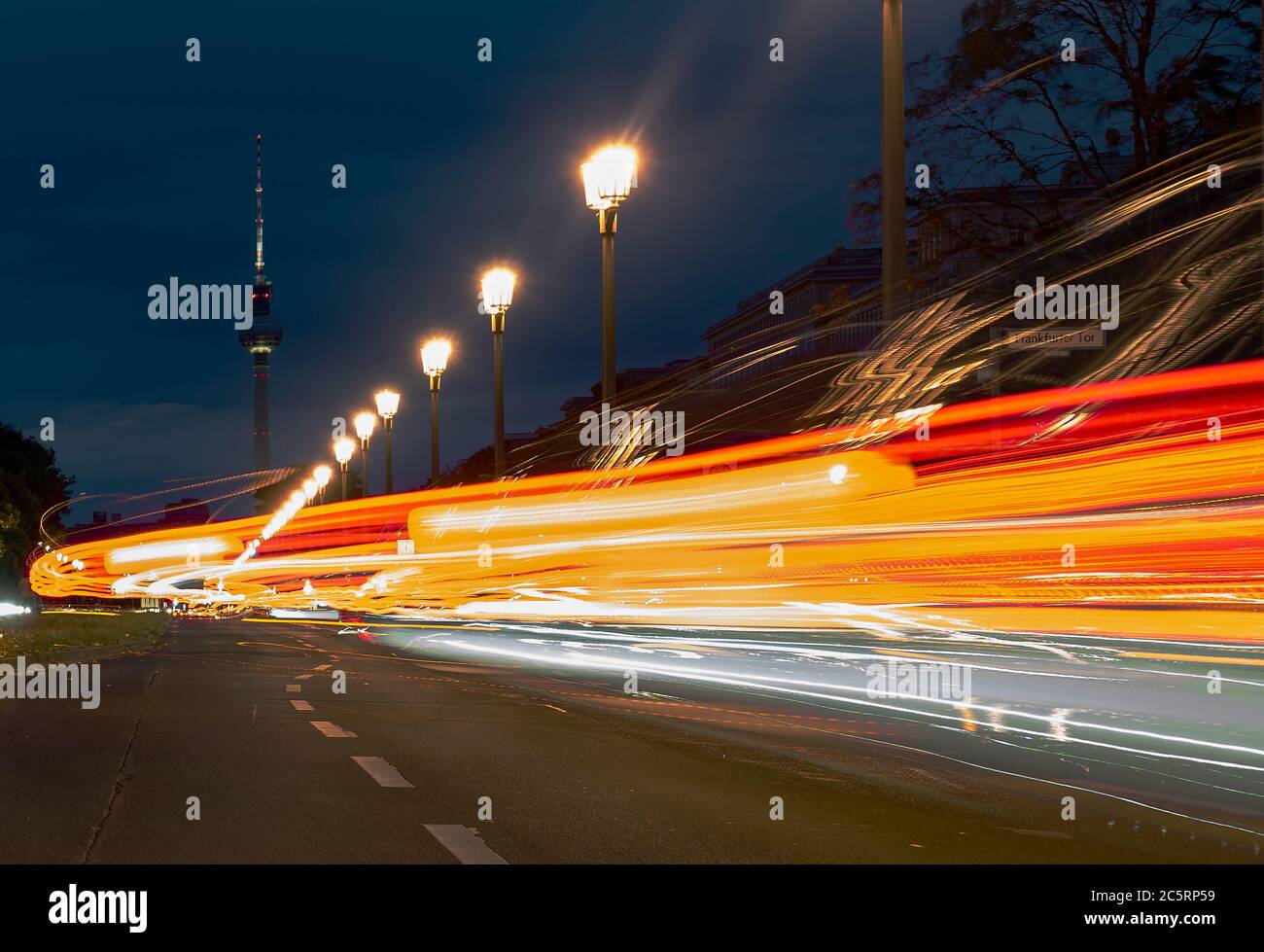 Berlin, Germany. 05th July, 2020. The vehicles on Karl Marx Allee in the direction of the television tower can only be recognised as coloured light strips. (shot with long time exposure) Credit: Paul Zinken/dpa/Alamy Live News Stock Photo