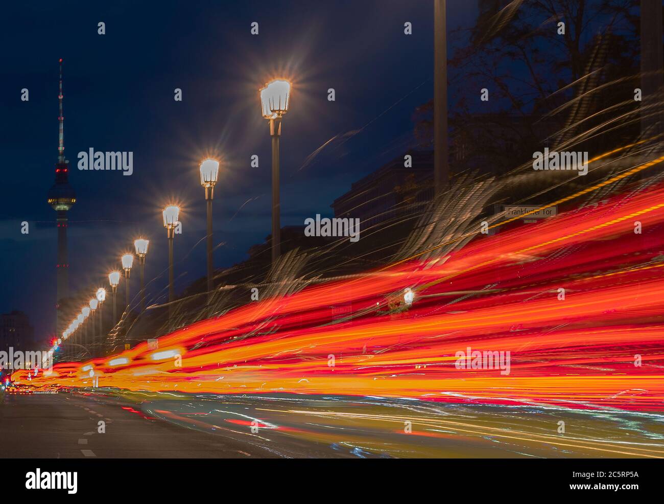 Berlin, Germany. 05th July, 2020. The vehicles on Karl Marx Allee in the direction of the television tower can only be recognised as coloured light strips. (shot with long time exposure) Credit: Paul Zinken/dpa/Alamy Live News Stock Photo