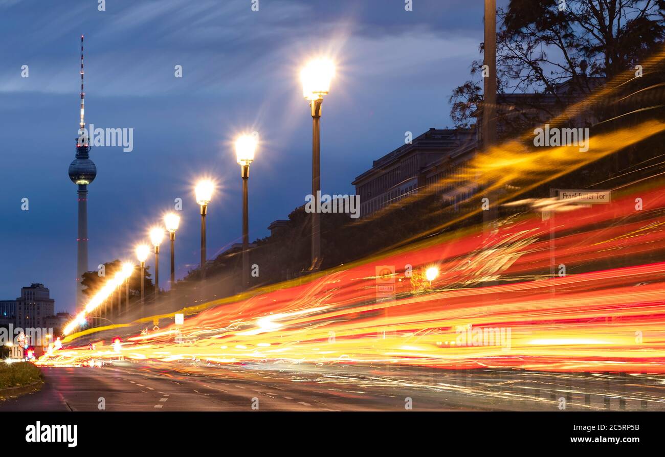 Berlin, Germany. 05th July, 2020. The vehicles on Karl Marx Allee in the direction of the television tower can only be recognised as coloured light strips. (shot with long time exposure) Credit: Paul Zinken/dpa/Alamy Live News Stock Photo