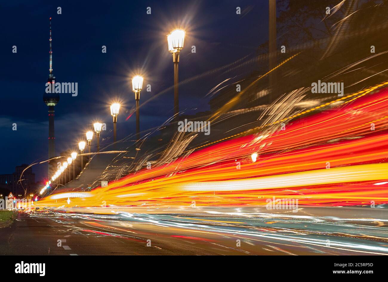 Berlin, Germany. 05th July, 2020. The vehicles on Karl Marx Allee in the direction of the television tower can only be recognised as coloured light strips. (shot with long time exposure) Credit: Paul Zinken/dpa/Alamy Live News Stock Photo