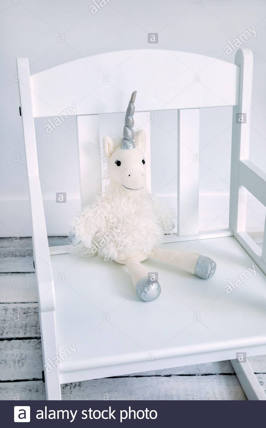 plush unicorn toy on a child's rocking chair stock photo  alamy