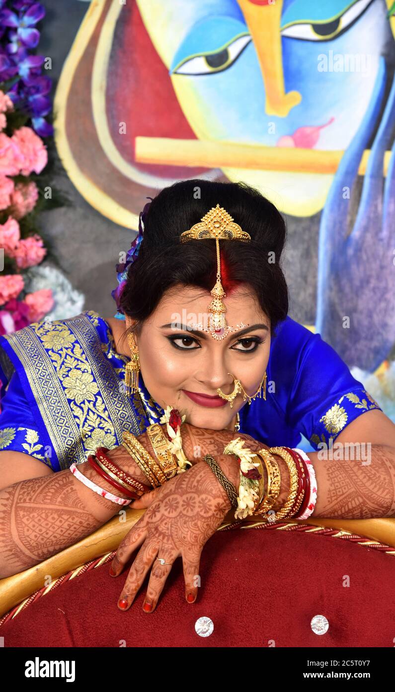 Stunning a beautiful Indian bride with gold jewelry very happy to