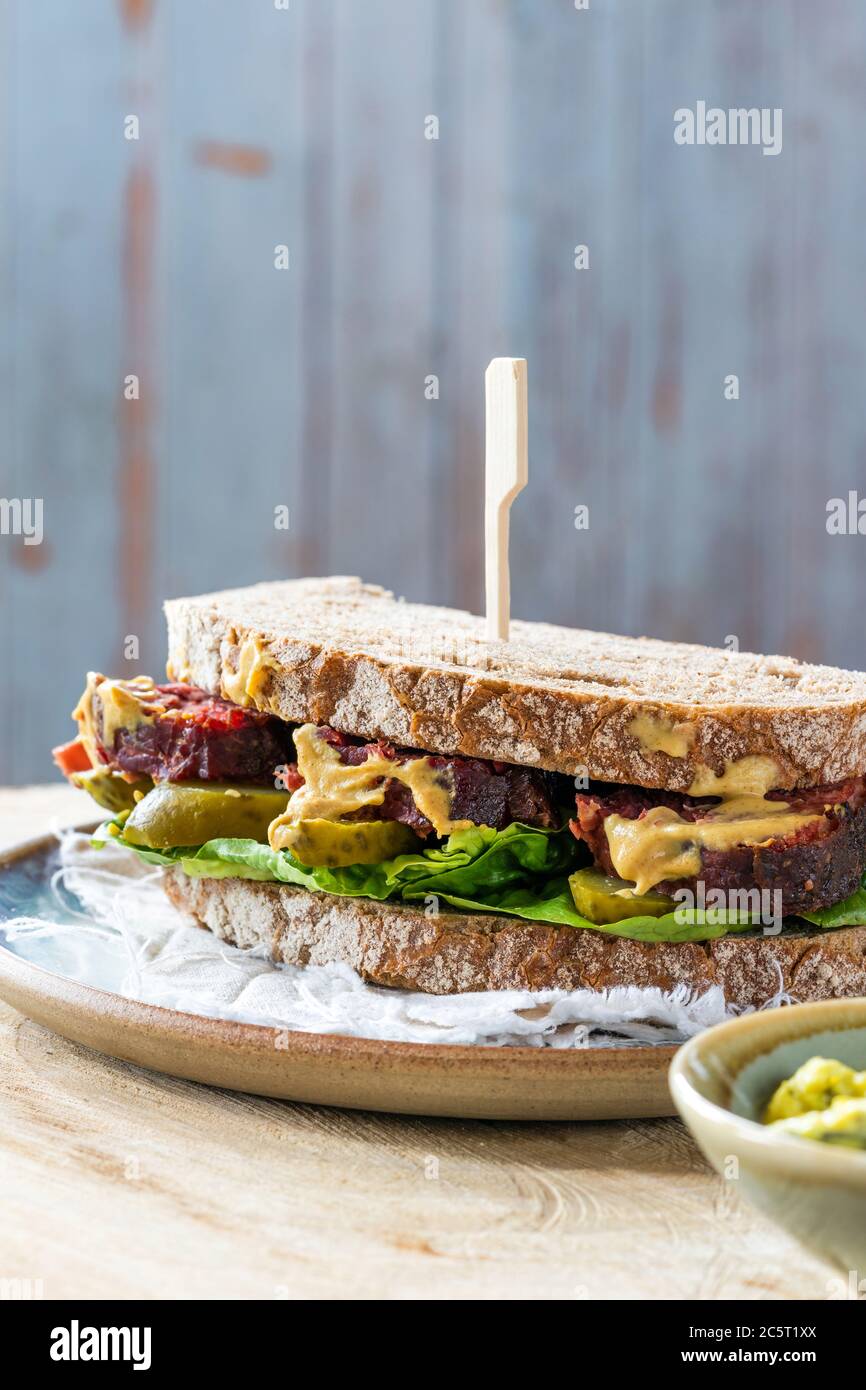 Salt beef sandwich with pickled cucumber and mustard tartar sauce Stock