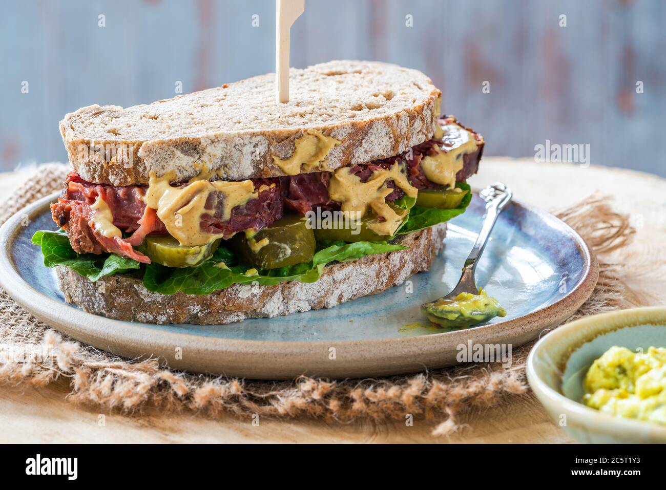 Salt beef sandwich with pickled cucumber and mustard tartar sauce Stock