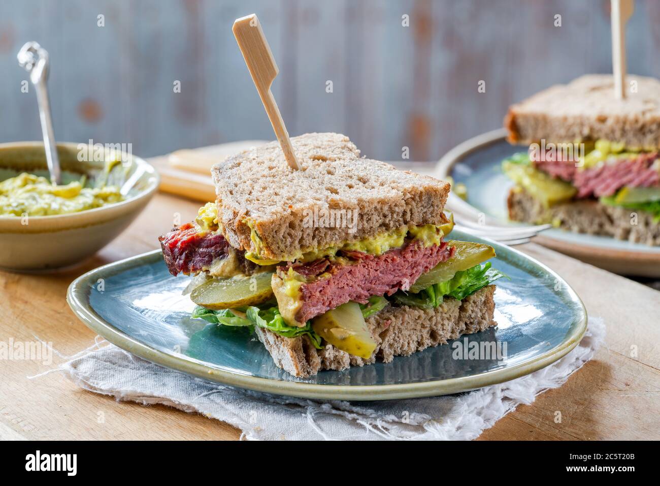 Salt beef sandwich with pickled cucumber and mustard tartar sauce Stock