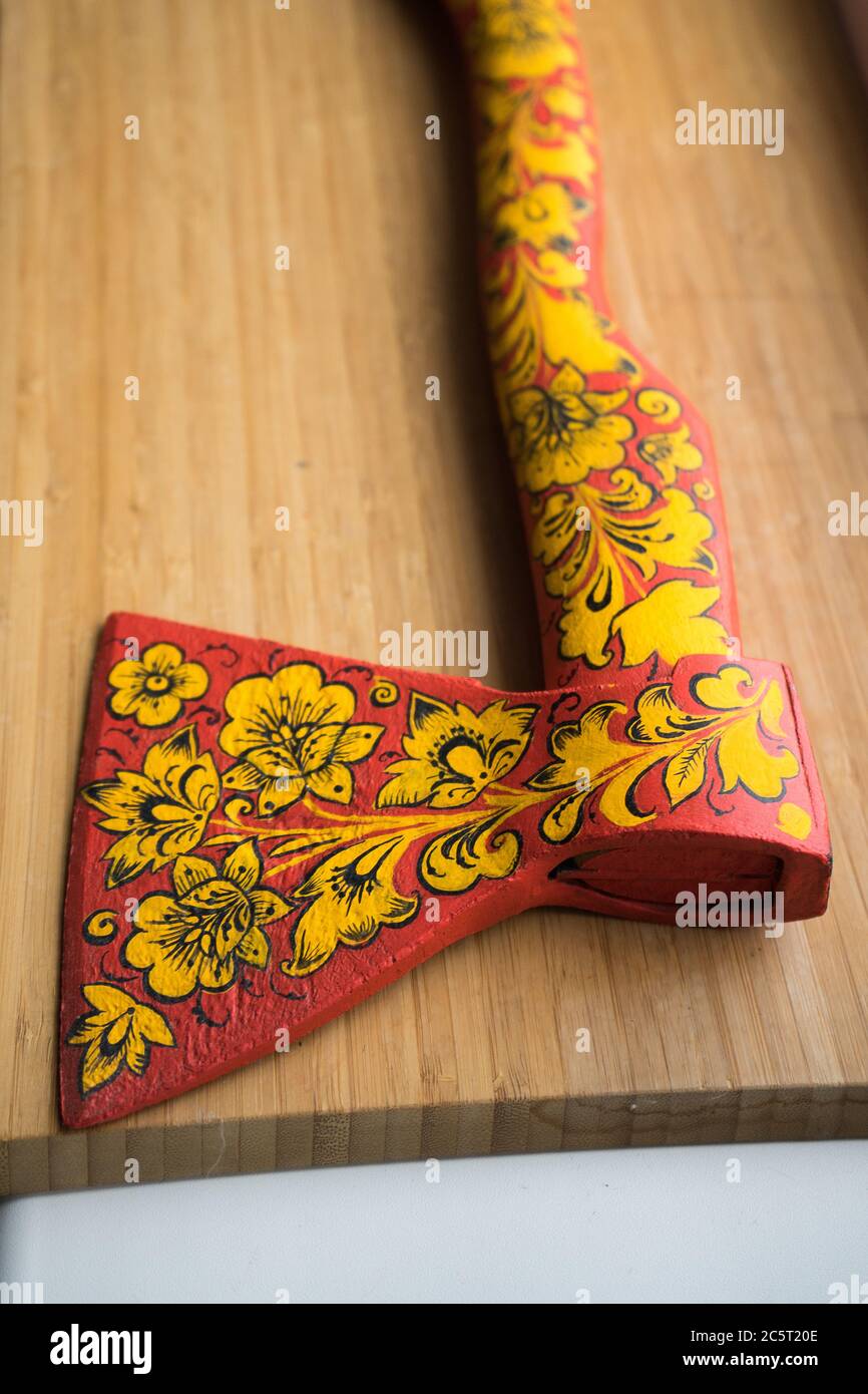 axe in Khokhloma. An axe painted in Russian folk style. Russian