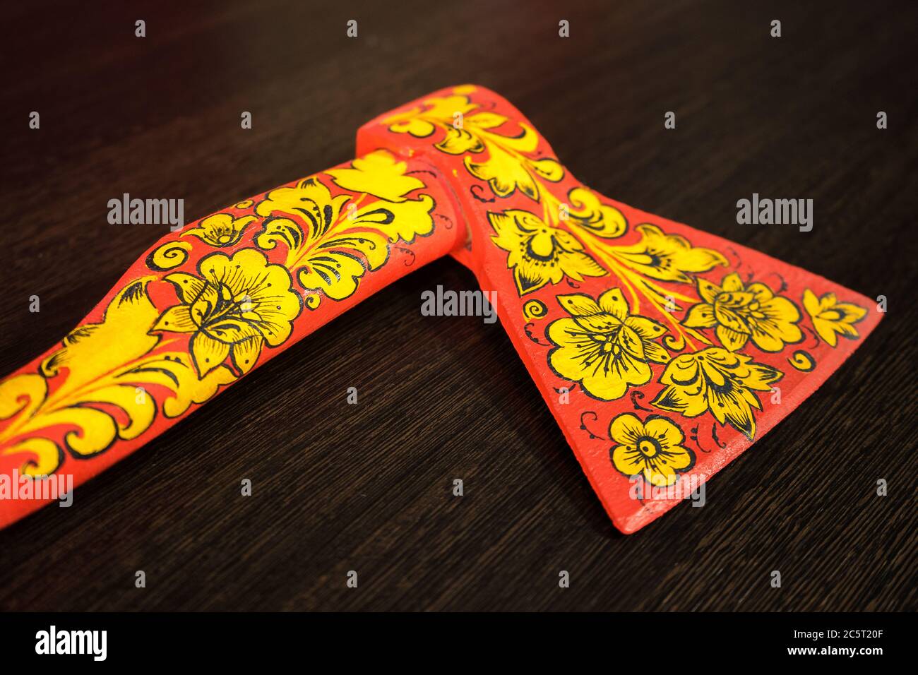 axe in Khokhloma. An axe painted in Russian folk style. Russian