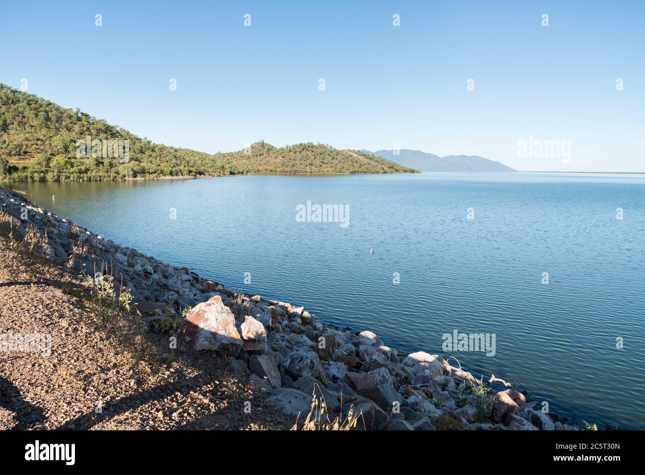 Townsville's Ross River Dam with high water level and clear blue sky