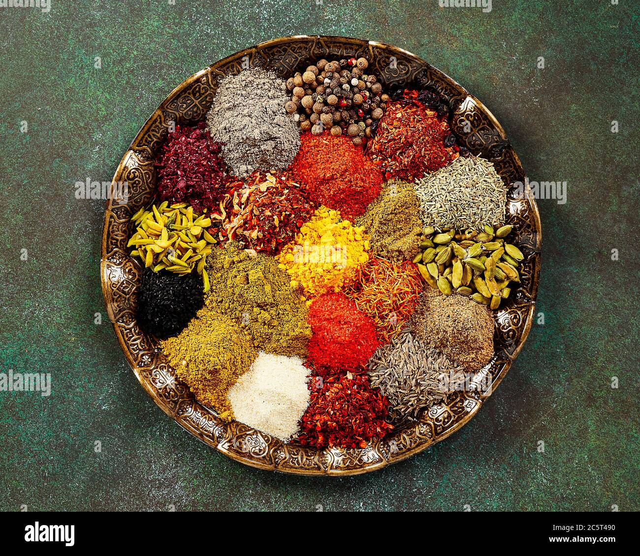 Various spice and dried herbs on oriental plate. Top view of spices Stock Photo