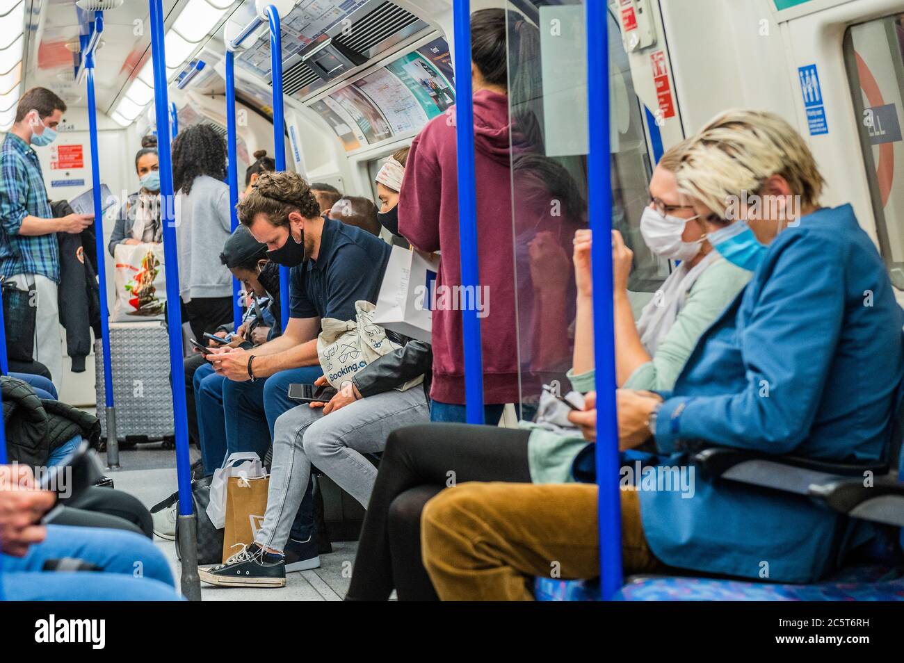 London, UK. 04th July, 2020. The underground is getting busier, on the day the pubs open. Those who do travel nearly all wear masks after they become mandatory on public transport. The 'lockdown' continues for the Coronavirus (Covid 19) outbreak in London. Credit: Guy Bell/Alamy Live News Stock Photo