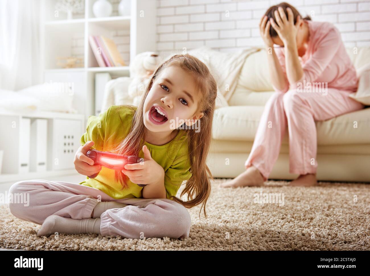 mother frustrating that her child playing video games Stock Photo