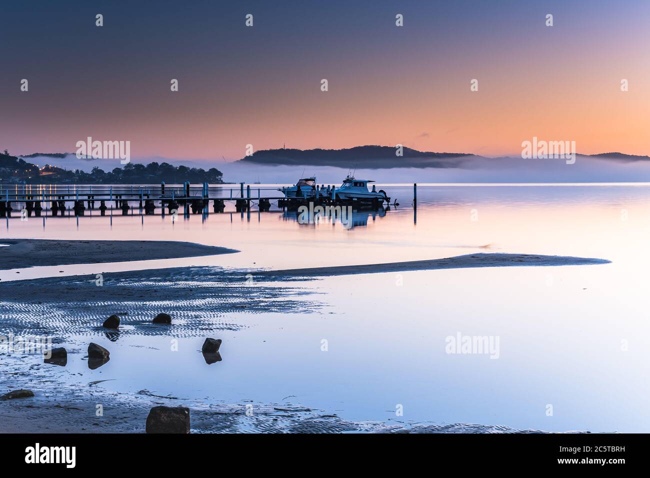 Misty Morning Sunrise Waterscape from Koolewong Waterfront on the Central Coast, NSW, Australia. Stock Photo