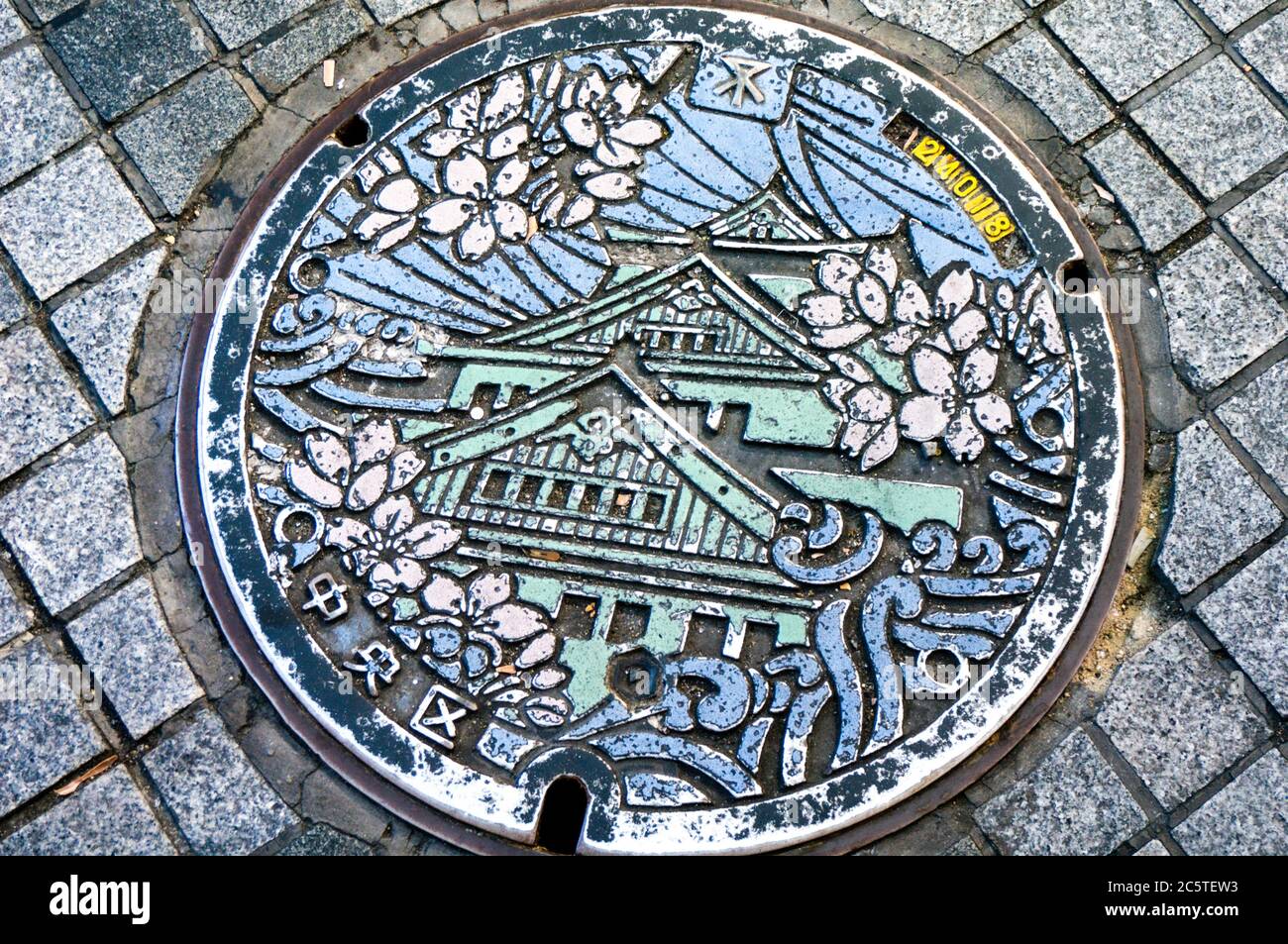 a manhole cover in Osaka with traditional patterns. Stock Photo