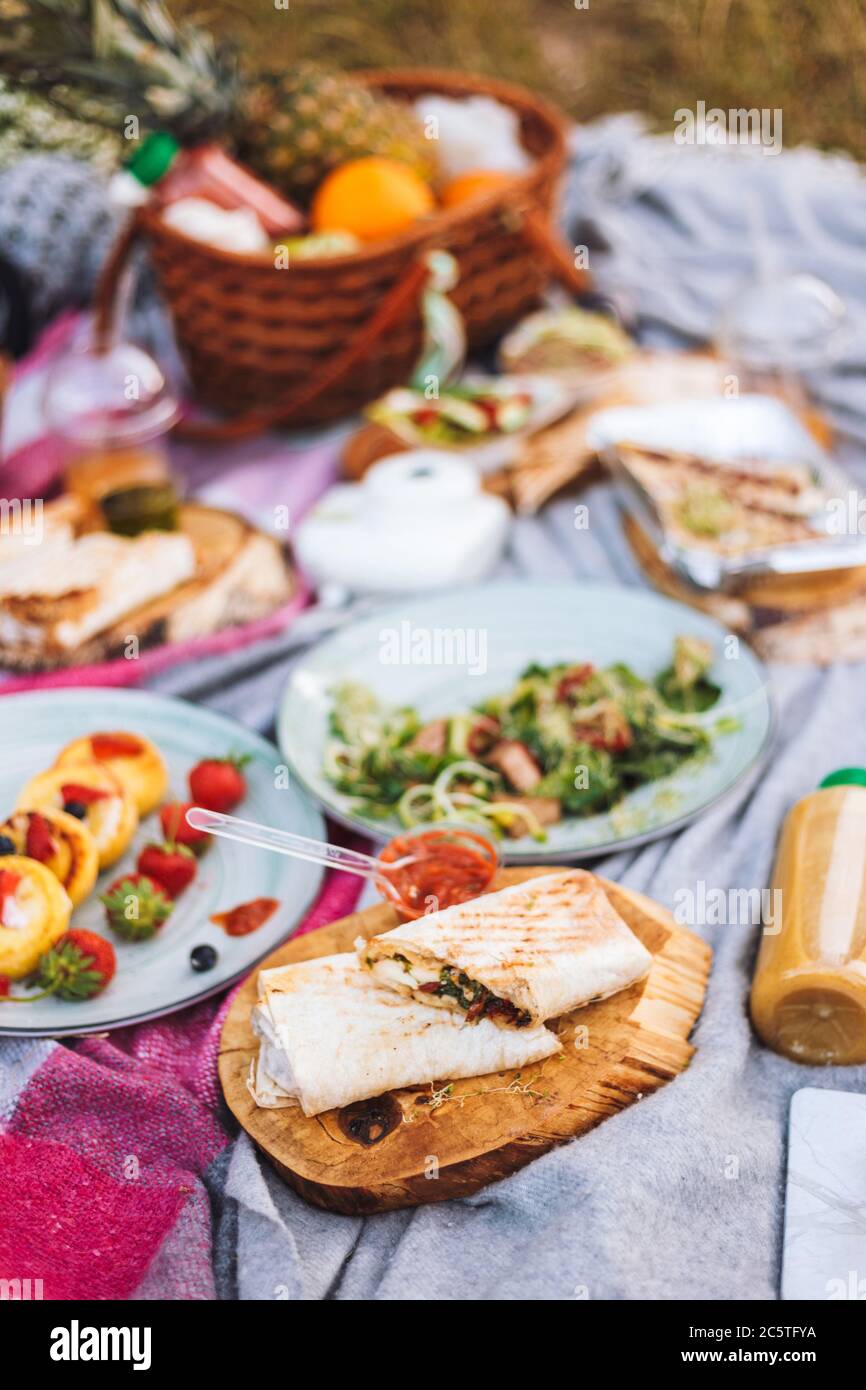Close up modern picnic with variety of tasty food and drinks on Stock