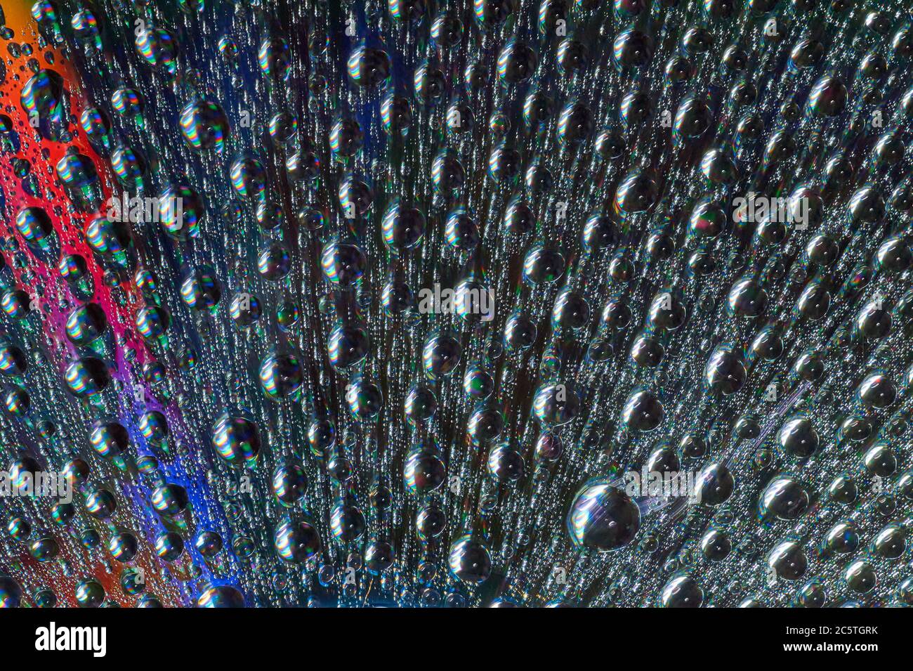 Macro of water drops on multicolor background Stock Photo - Alamy