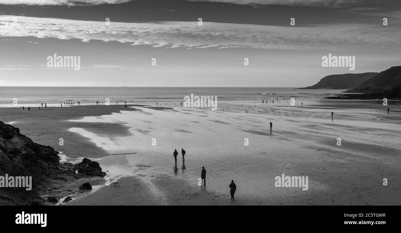 Christmas morning walkers at Caswell Bay, Gower Peninsular, Swansea, Wales Stock Photo