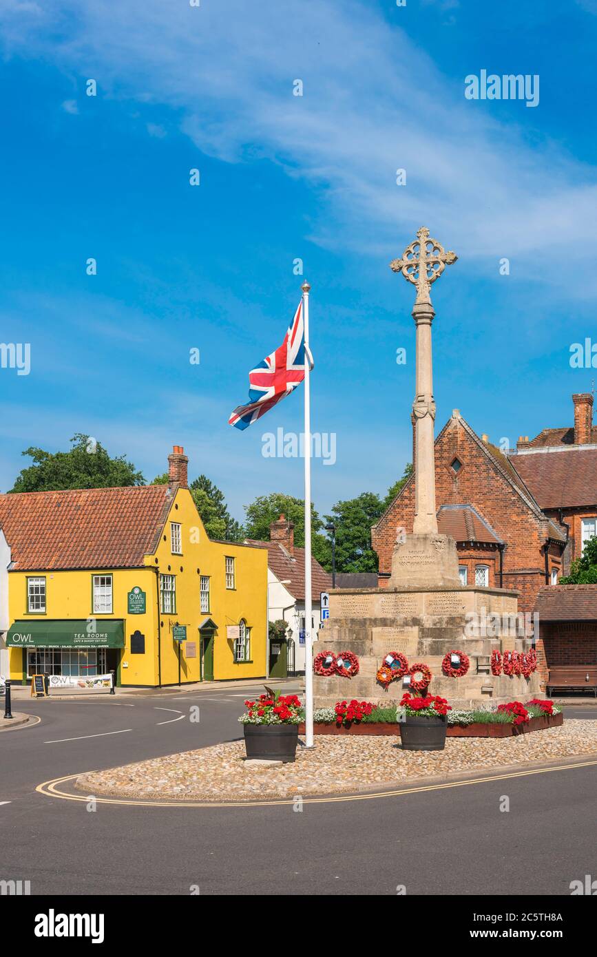 Holt Norfolk UK, view in summer of the Market Place in Holt village showing the war memorial at its centre, Norfolk, East Anglia, UK Stock Photo