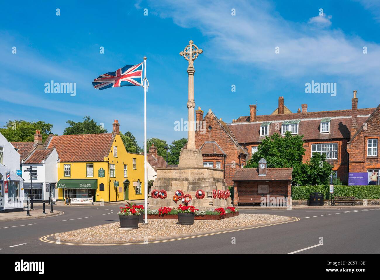 Holt Norfolk England, view in summer of the Market Place in Holt village showing the war memorial and (at rear) Gresham's School, Norfolk, UK Stock Photo