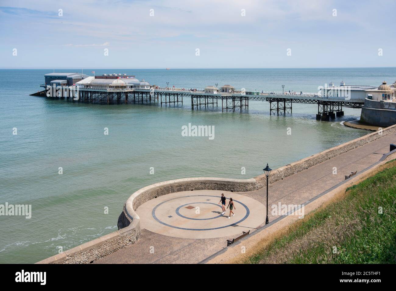 Pier Cromer Norfolk UK, view in summer of the esplanade and Edwardian era pier in the seaside town of Cromer, Norfolk, England, UK Stock Photo