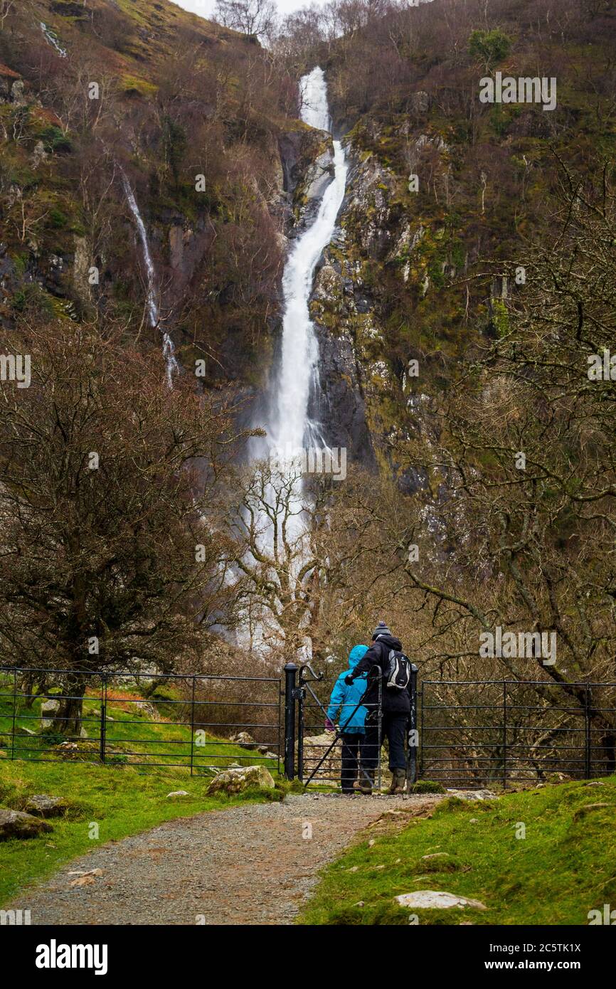 Walkers on the footpath to the Aber Falls, Wales Stock Photo