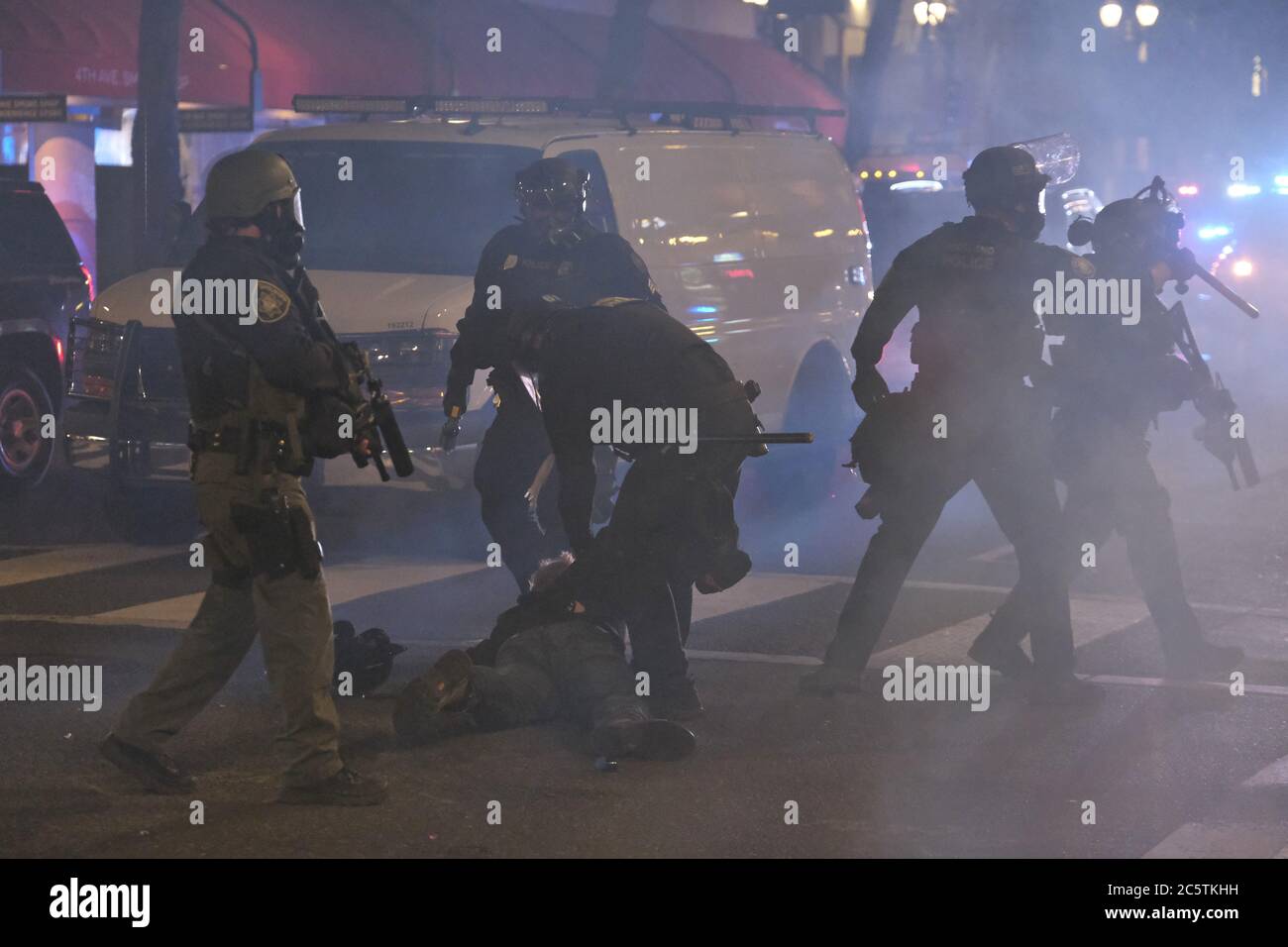 Police make an arrest amidst a haze of tear gas after a riot was declared in Portland, Ore., on July 4, 2020. (Photo by Alex Milan Tracy/Sipa USA) Stock Photo