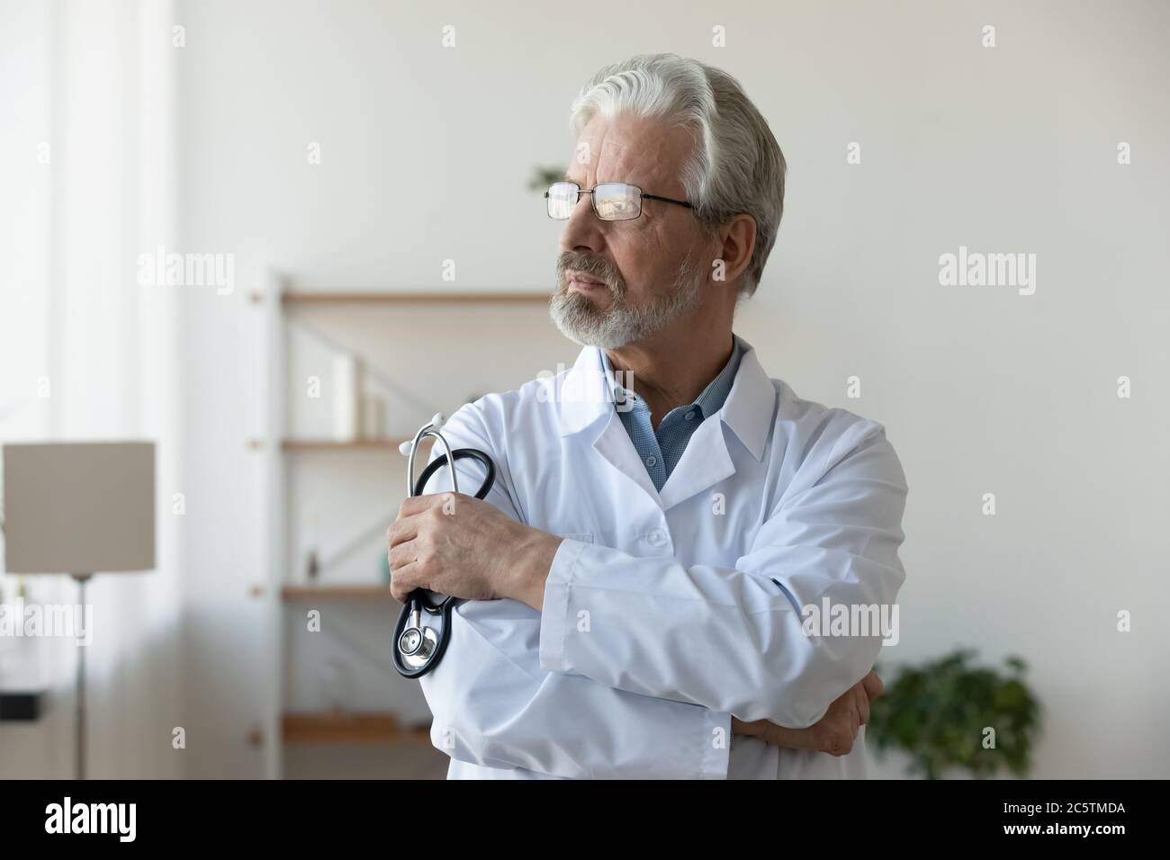 Mature male doctor thinking hi-res stock photography and images - Alamy