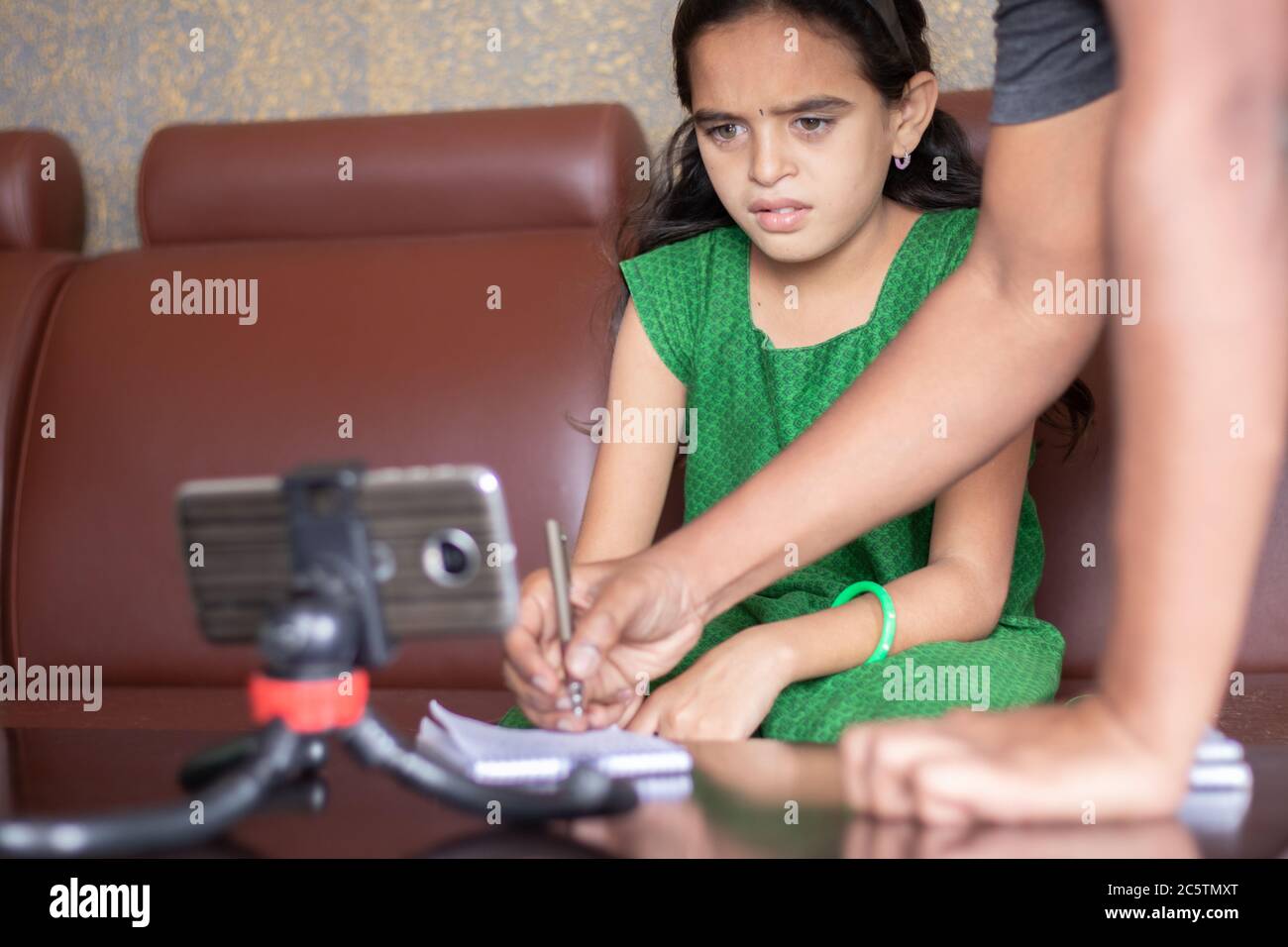 Father helping daughter by solving problem while studying the lesson from online class or e-learning - concept of Role of parents in supporting child Stock Photo
