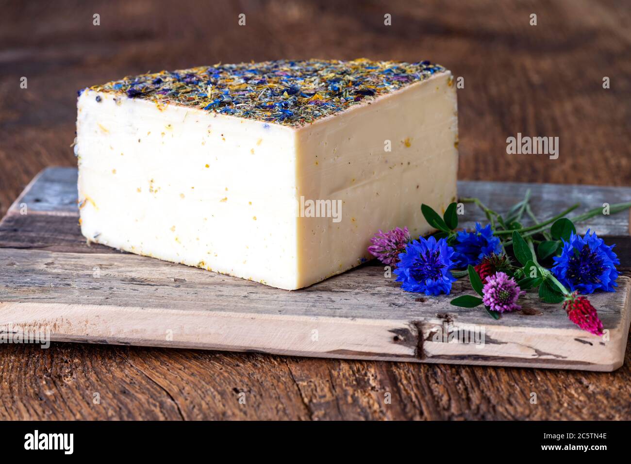 mountain cheese with flowers on wood Stock Photo