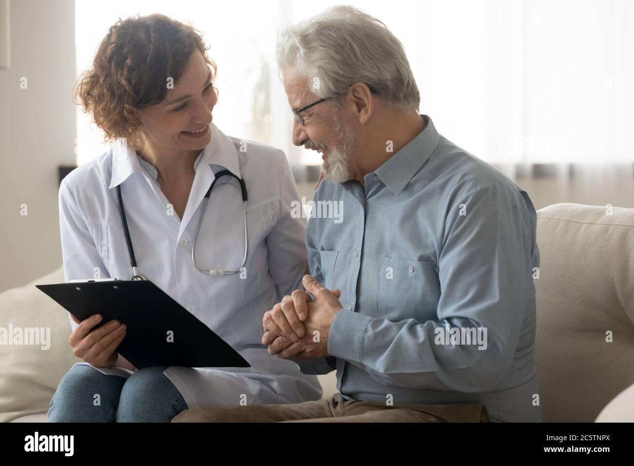 Happy smiling mature doctor hi-res stock photography and images - Alamy