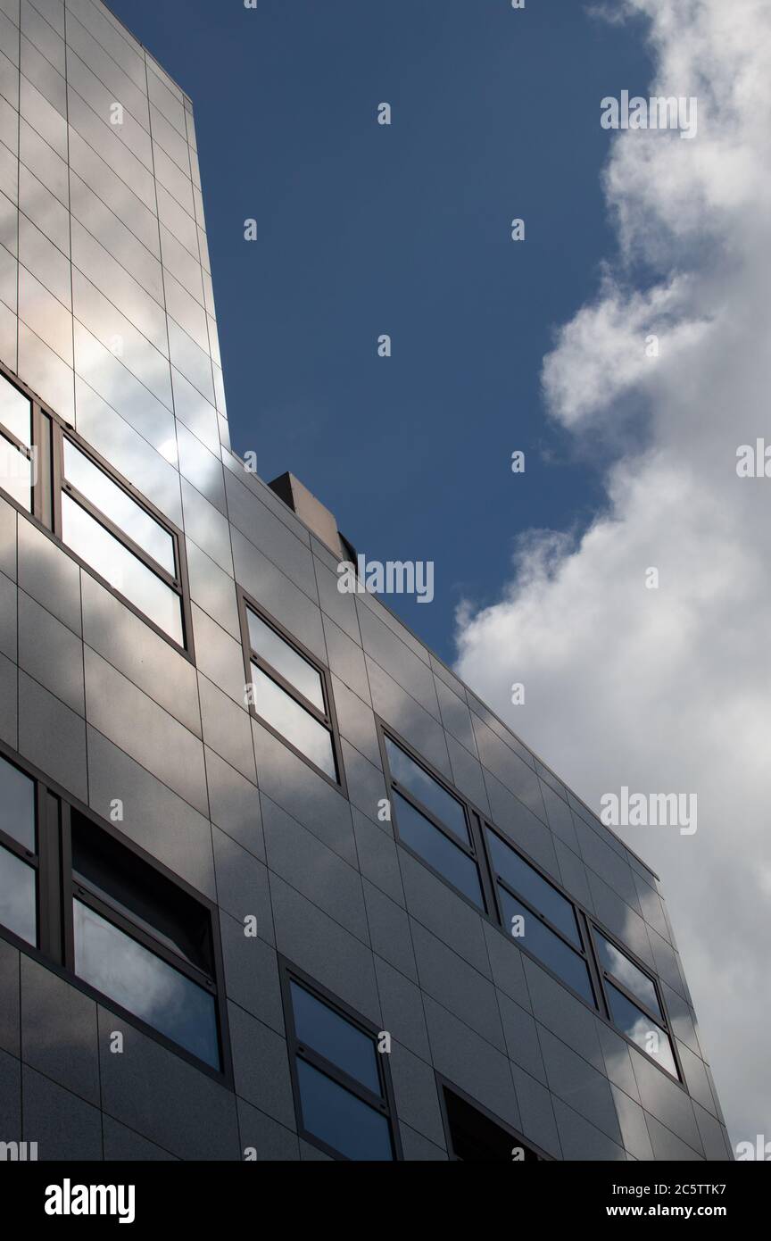 Sunlight and clouds reflecting in a modern office building Stock Photo ...