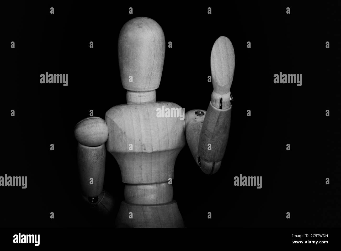 Wooden Human Manikin posing on a black background Stock Photo Alamy