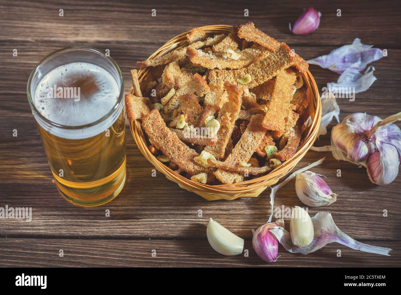 A bouquet of fresh beer and snacks with homemade, salted, rye rusks with garlic for beer. Very tasty homemade beer appetizer. Stock Photo