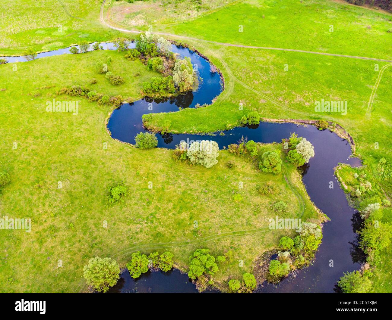 aerial drone landscape of river in green field, top view of beautiful ...
