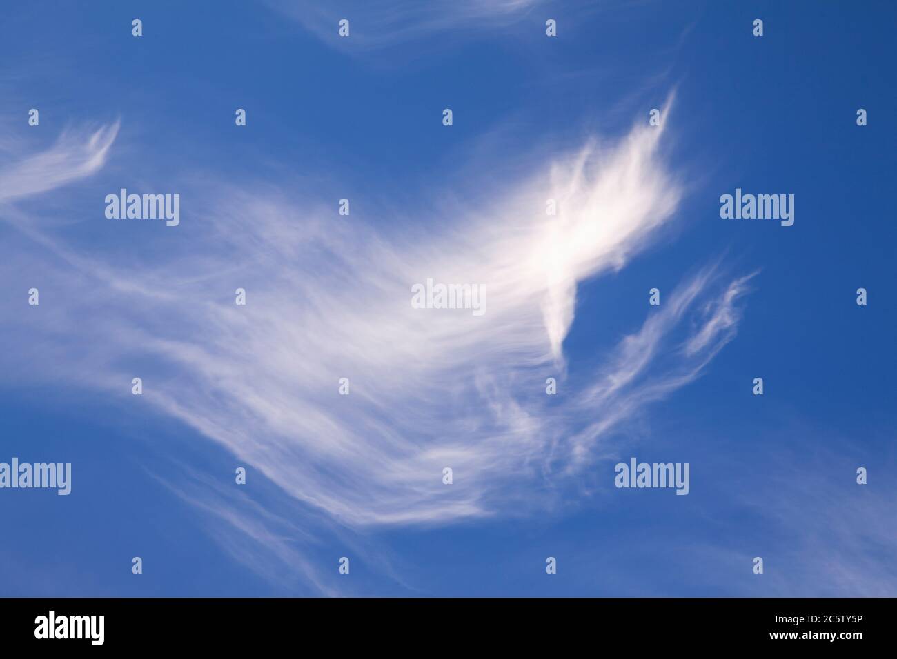 High altitude cirrus clouds against a blue sky Stock Photo