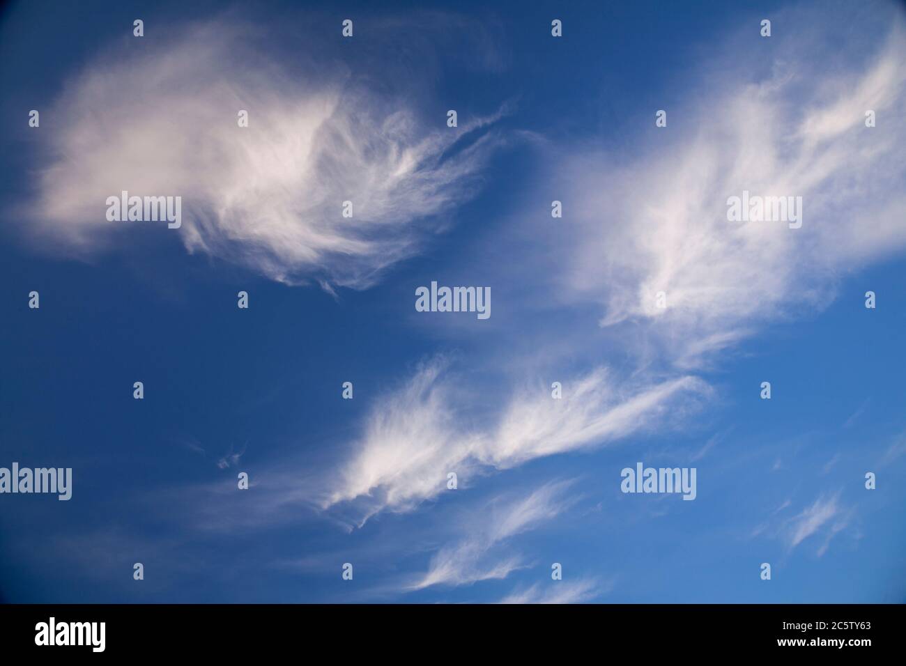 High altitude cirrus clouds against a blue sky Stock Photo