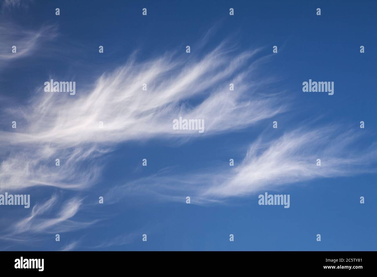 High altitude cirrus clouds against a blue sky Stock Photo