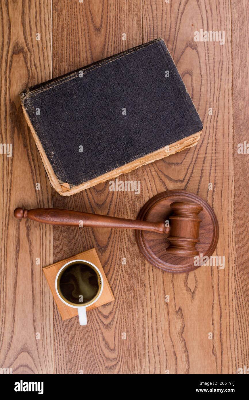 Judges hammer with old book and cup of coffee. Stock Photo