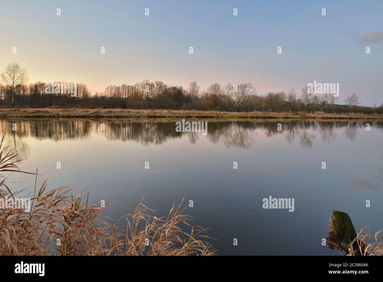 Sunset over a wide river on a cool spring day. Fish eye lens. Spring. Stock Photo