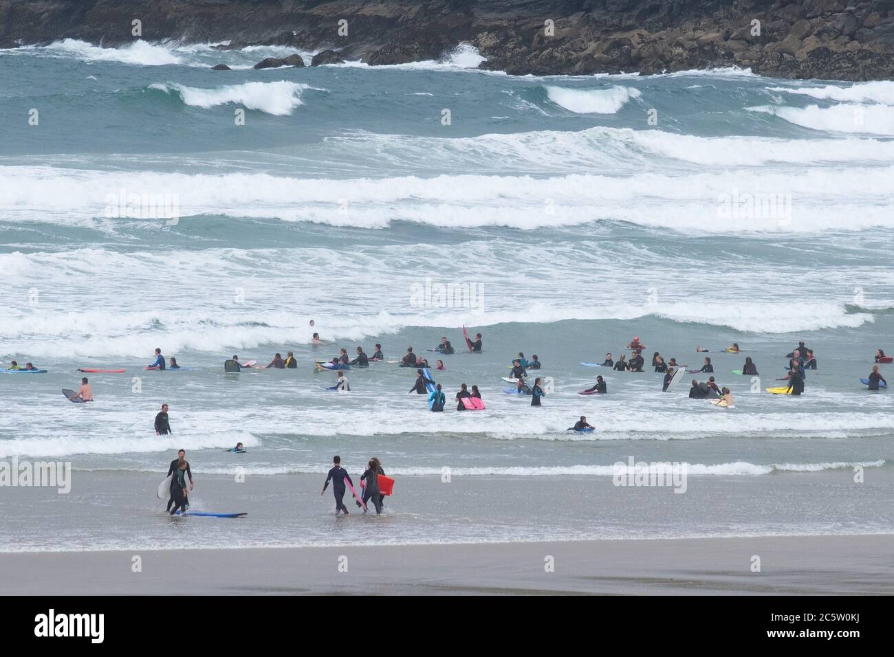 Polzeath, Cornwall, UK. 5th July 2020. UK Weather.  With the influx of visitors to Cornwall over the weekend the sea at Polzeath was looking decidely busy this lunchtime. Credit CWPIX / Alamy Live News. Stock Photo