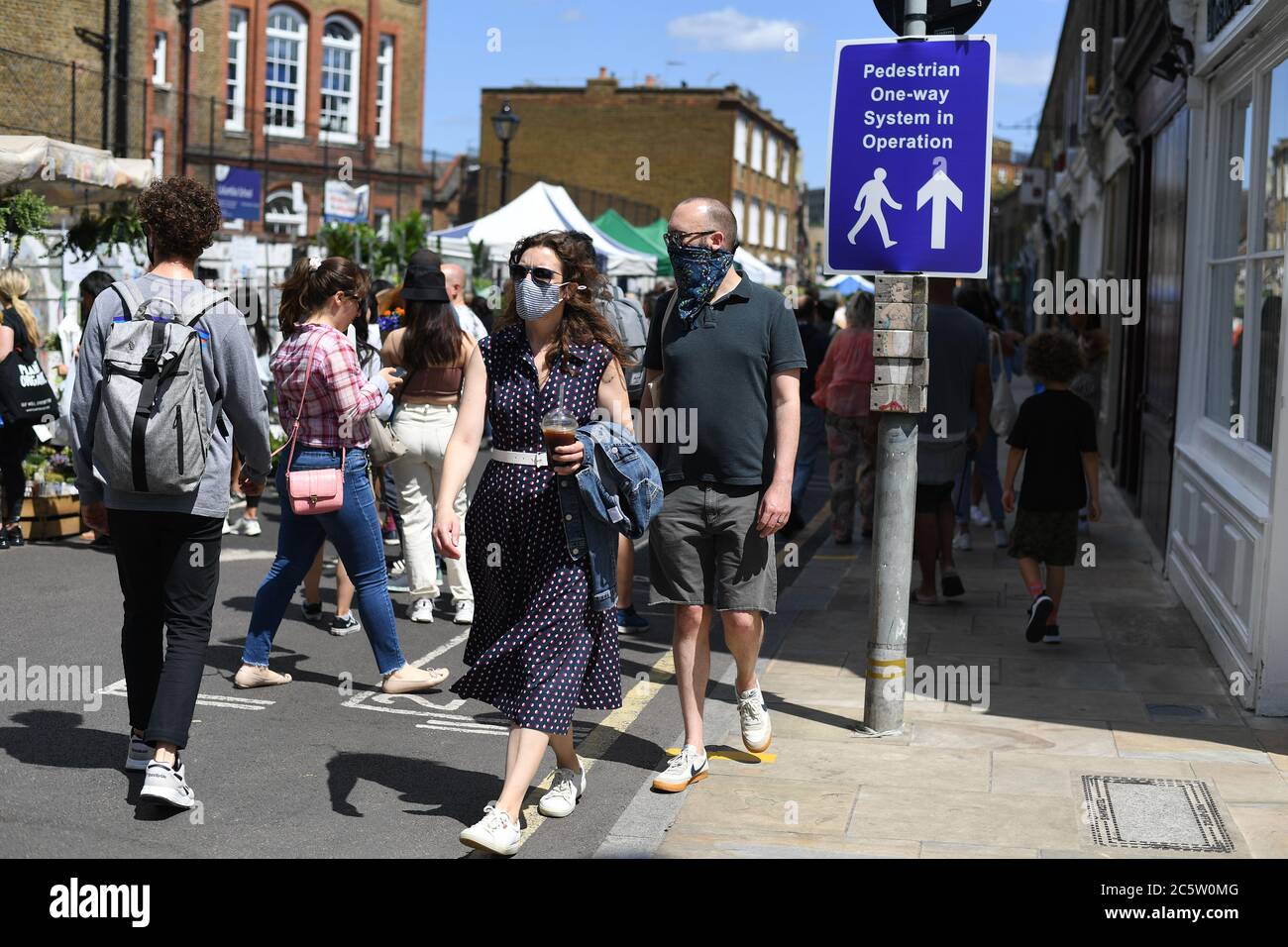 A one way system sign at Columbia Road Flower Market, London, as it reopens following the easing of coronavirus lockdown restrictions across England. Stock Photo