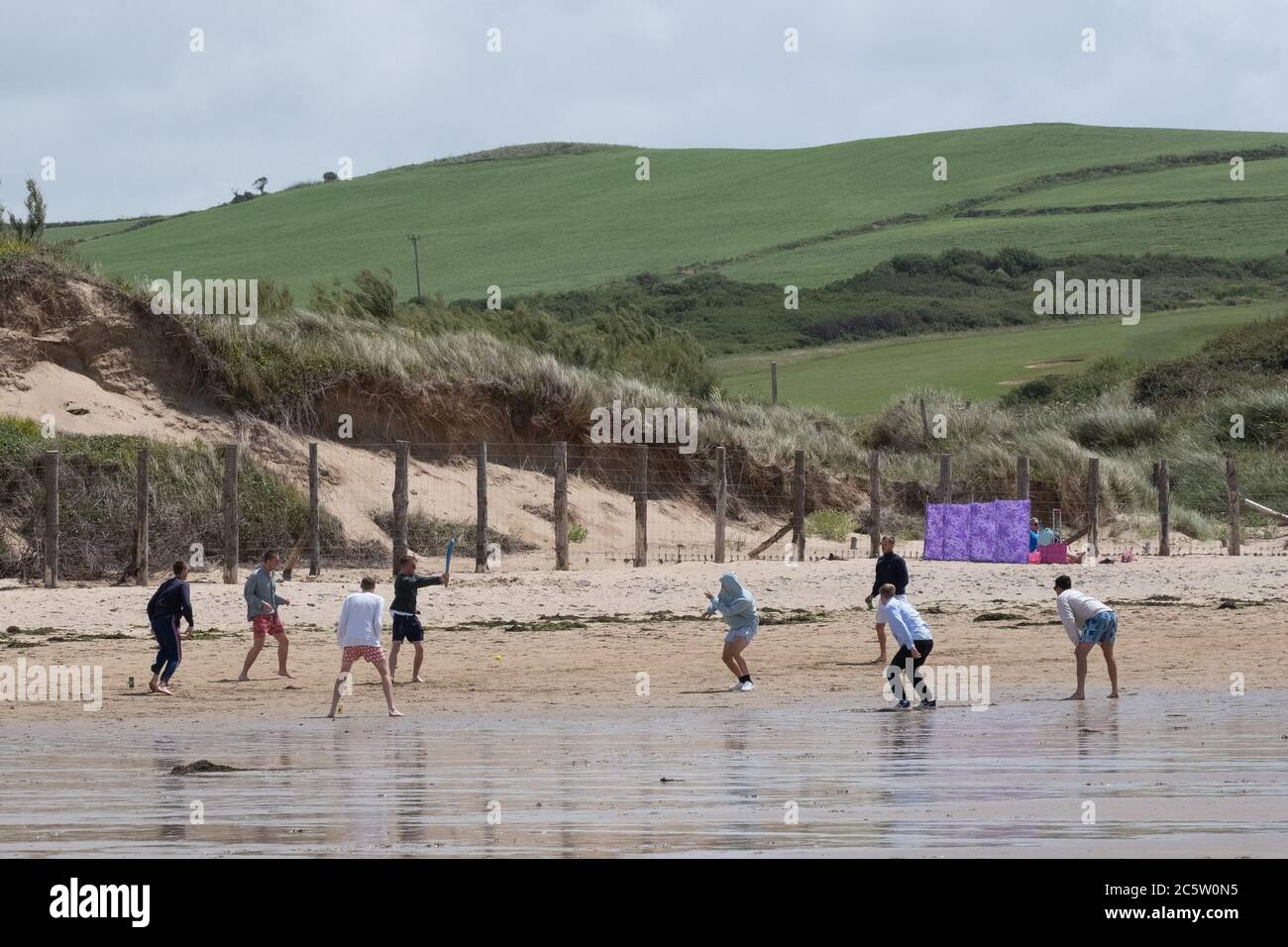 Daymer Bay, Rock, Cornwall, UK. 5th July 2020. UK Weather. A strong wind didn't keep people off the beach at Daymer bay this lunchtime. Ideal weather for a spot of windsurfing. Credit CWPIX /  Alamy Live News. Stock Photo
