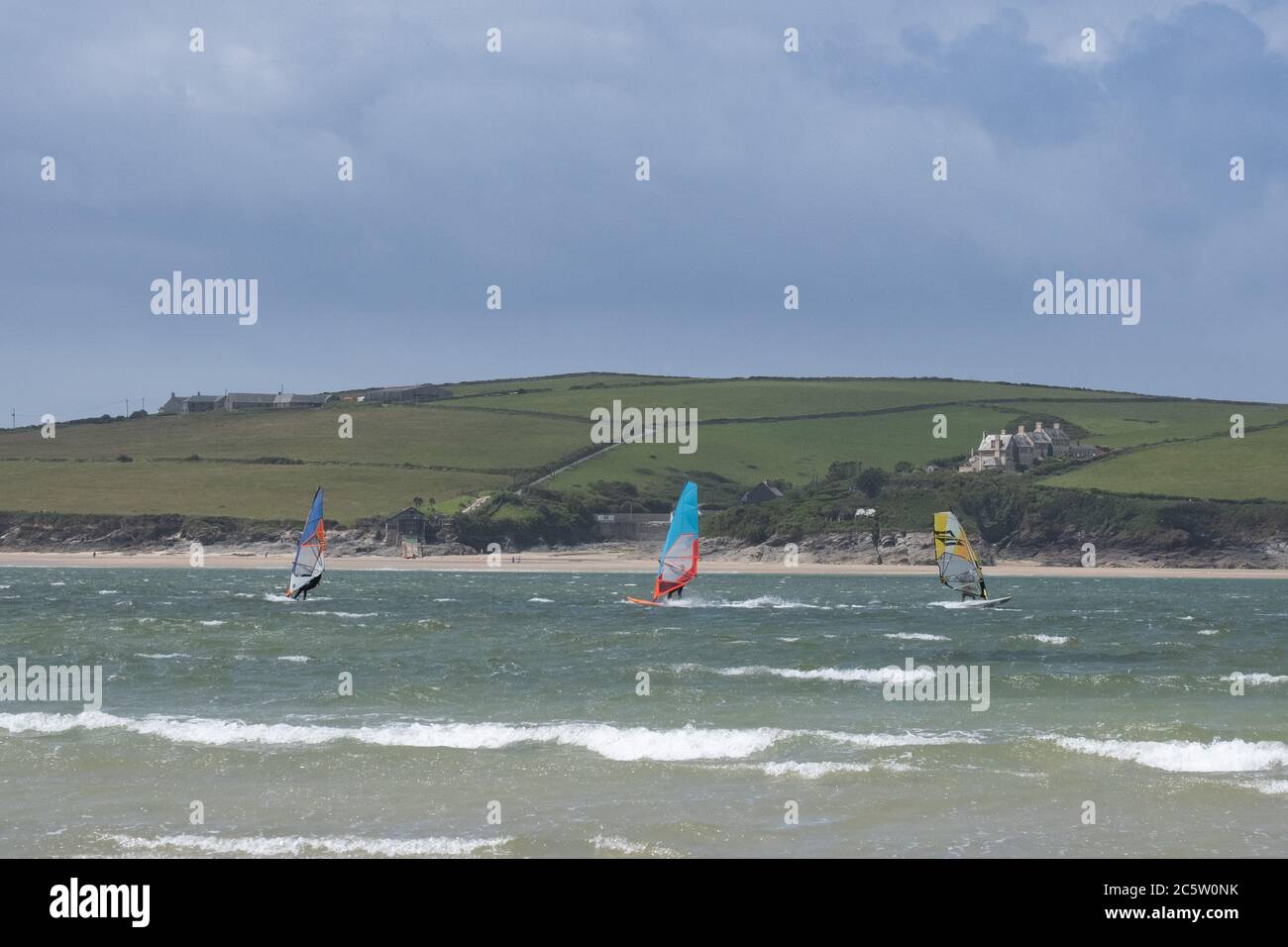 Daymer Bay, Rock, Cornwall, UK. 5th July 2020. UK Weather. A strong wind didn't keep people off the beach at Daymer bay this lunchtime. Ideal weather for a spot of windsurfing. Credit CWPIX /  Alamy Live News. Stock Photo