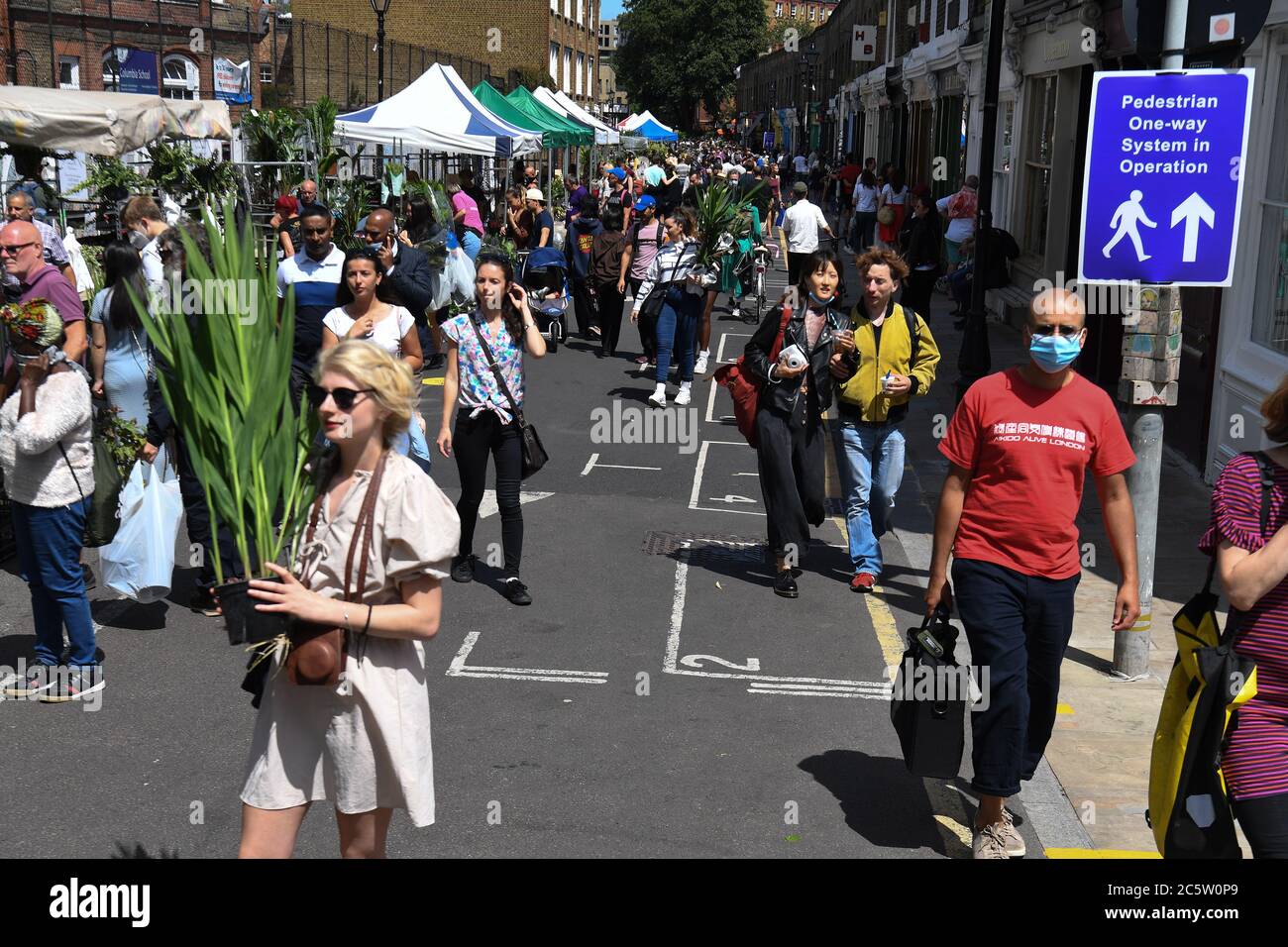 A one way system in place at Columbia Road Flower Market, London, as it reopens following the easing of coronavirus lockdown restrictions across England. Stock Photo