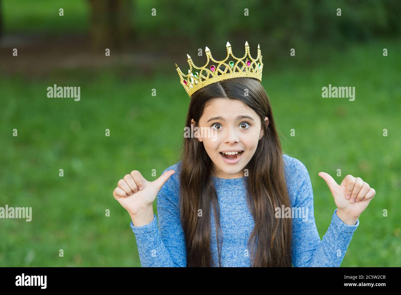 My beauty deserves crown. Emotional child give thumbs ups. Little miss wear crown. Beauty pageant. Party crown. Fashion accessory. Luxury diadem or tiara. Big boss. Hair salon. Always wear your crown. Stock Photo