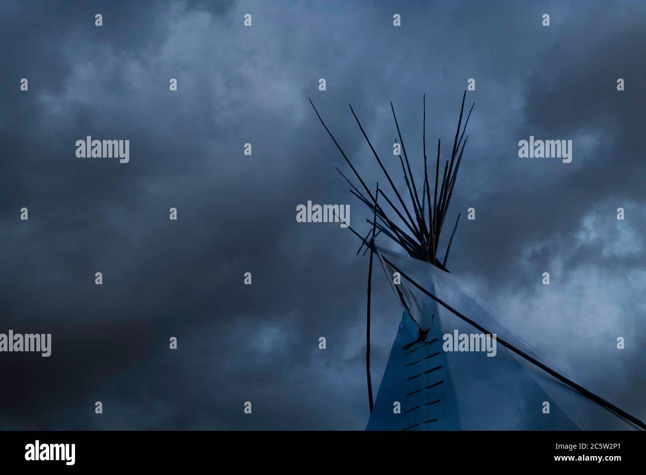 A First Nations Indian teepee (or tipi) emerging from a misty cloud on a rainy day in Canada Stock Photo