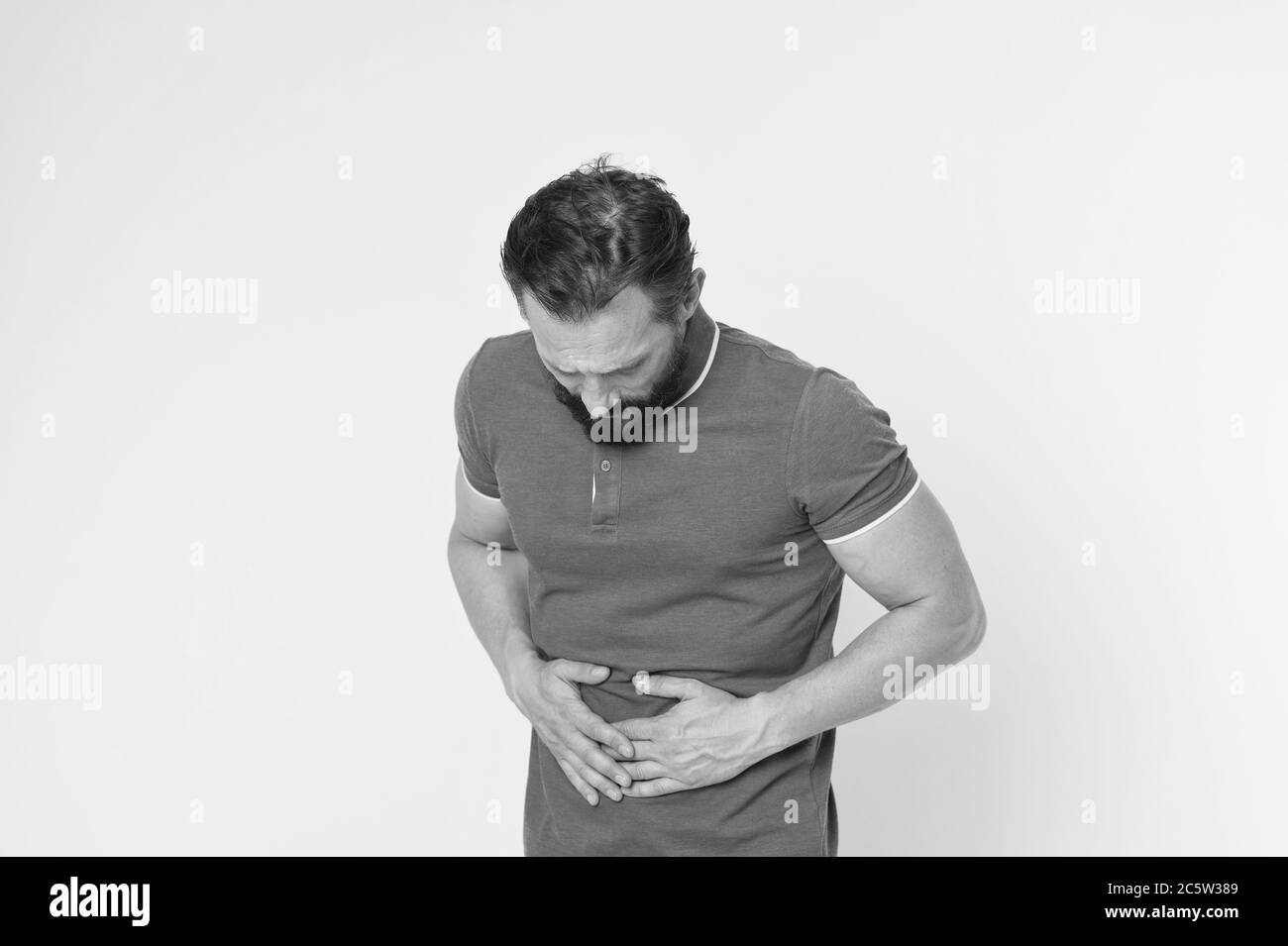 Sore stomach is killing me. Sick man suffer from stomach ache