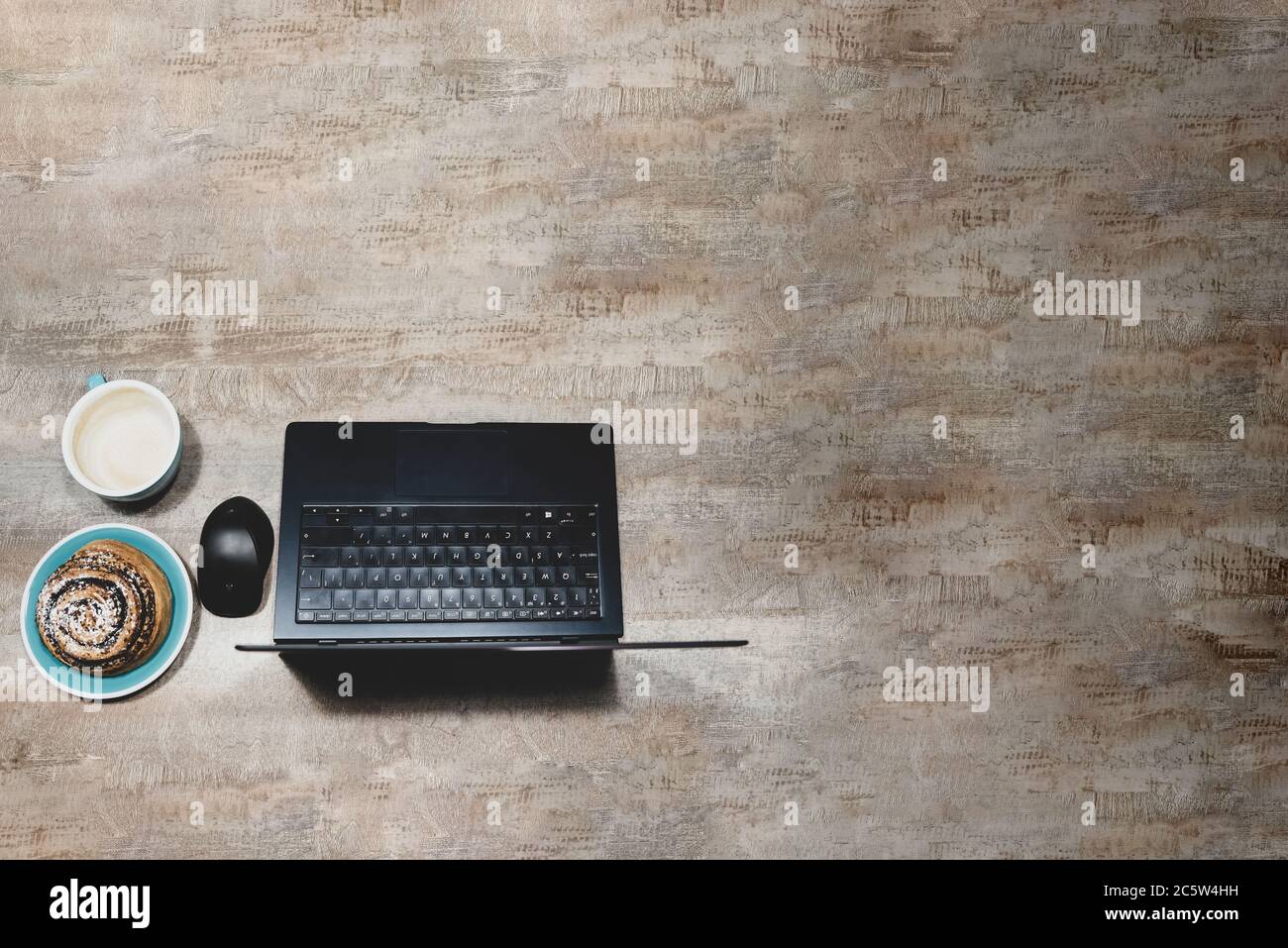 Flat layout of table with laptop, computer mouse, Cup of coffee and poppy  seed bun on wooden surface Stock Photo - Alamy