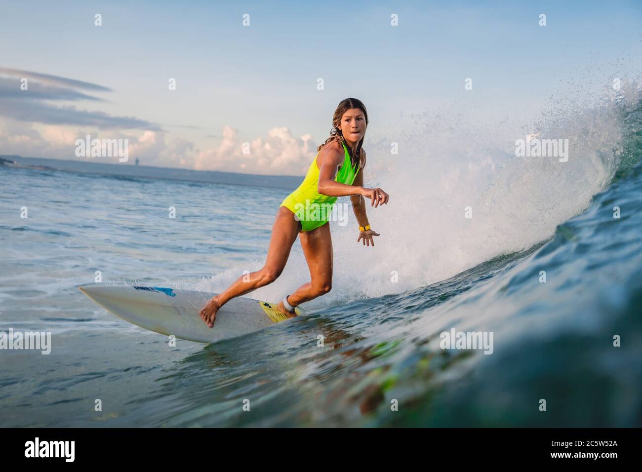 April 16, 2020. Bali, Indonesia. Surf girl ride on surfboard. Surfers