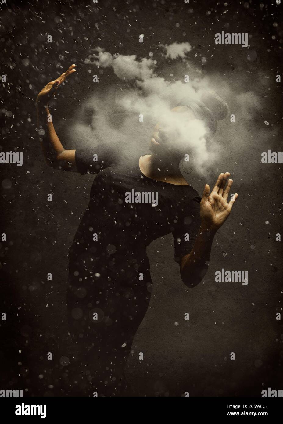 A girl in the dark, looking for a way with her head hidden behind the fog Stock Photo