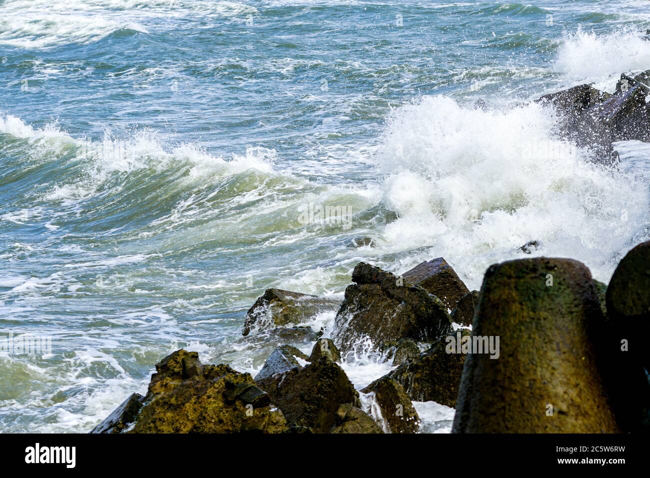 view of the stormy sea, waves splashing against the concrete pier Stock ...